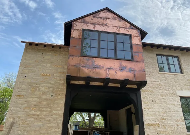 Copper metal panel facade on a stone building for Skylight Installation in Eastlake