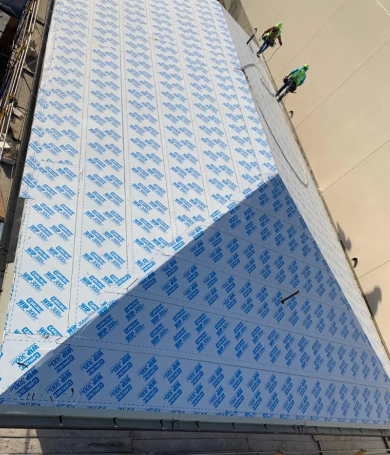 Professional roofers installing underlayment on a metal roof in Eastlake